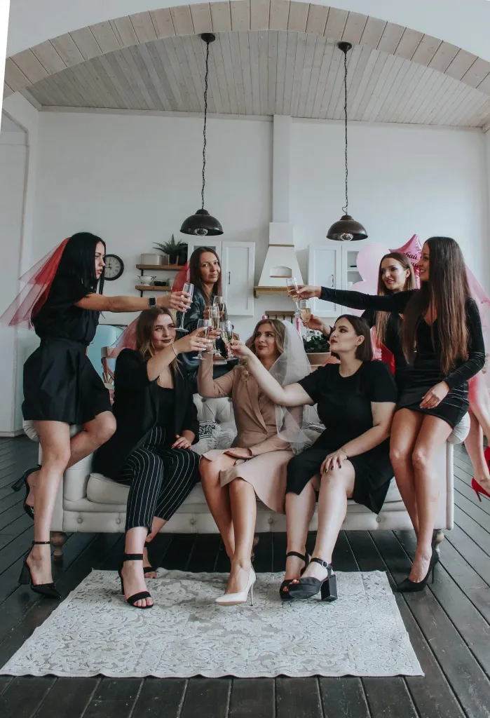 group of women posing for a photo on a sofa