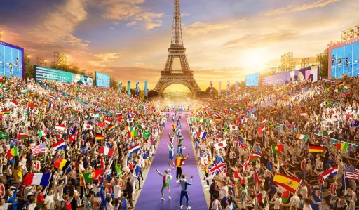 Large crowd waves flags in front of the Eiffel Tower during an event at sunset.