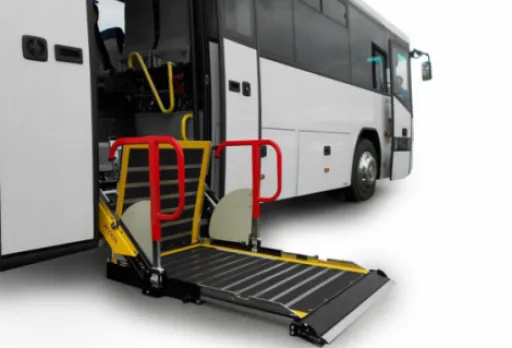 Bus with a deployed wheelchair ramp and safety railings at the entrance.