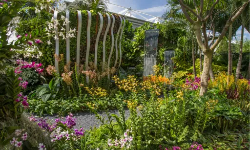 Vibrant garden filled with various flowers, greenery, and decorative features.